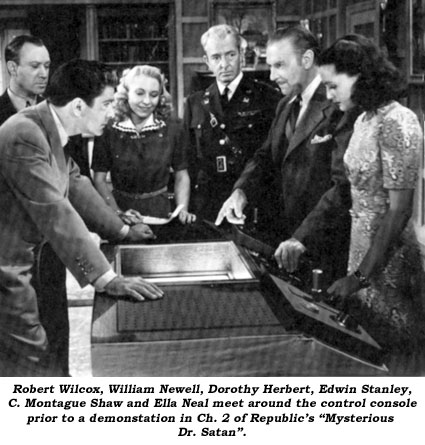 Robert Wilcox, William Newell, Dorothy Herbert, Edwin Stanley, C. Montague Shaw and Ella Neal meet around the control console prior to a demonstration in Ch. 2 of Republic's "Mysterious Dr. Satan".