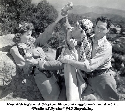 Kay Aldridge and Clayton Moore struggle with an Arab in "Perils of Nyoka" ('42 Republic).