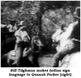Bill Tilghman makes Indian sign language to Quanah Parker (right).