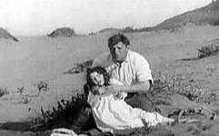Broncho Billy and child in desert in "Outlaw and the Child" (1911).