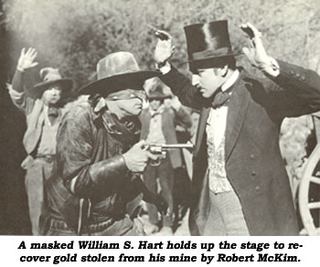 A masked William S. Hart holds up the stage to recover gold stolen from his mine by Robert McKim.