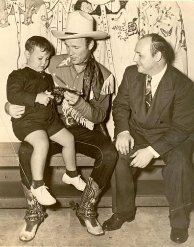An odd combination! Roy Rogers, King of the Cowboys, with Irving Klaw, King of the Pin-ups--as in Bettie Page--with Klaw's son Arth Klaw at age 4 backstage at the Madison Square Garden Rodeo in 1944.