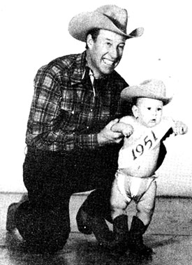 Bill Elliott was in Cisco, TX, just before Christmas 1950 to represent BACK IN THE SADDLE horseman magazine in thier annual Christmas parade. While in Cisco Bill posed for the above two pictures with 14 month old Bonnie Jo Steffen, editor Randy Steffen’s daughter. The photo on the left was used for the cover of BACK IN THE SADDLE (1/51) and the other was used in the interior of the magazine. The photo below was taken in the offices of BACK IN THE SADDLE.