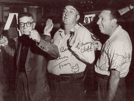 A local look-alike for the great stoneface, comedian Buster Keaton, and the real Frog, Smiley Burnette, do a little clowning around with THE CLARION LEDGER photographer, Cliff Bingham, in Jackson, MS. (Thanx to Danny Brown and Marjorie Bowron.)