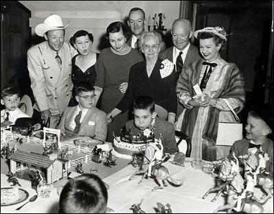 Roy Rogers and Dale Evans help Mamie Eisenhower (next to Roy), Barbara and John Eisenhower (son and daughter-in-law of the president), unknown relative?, and President Dwight D. Eisenhower celebrate grandson David's birthday at the White House in 1956. (Photo courtesy Jerry Dean.