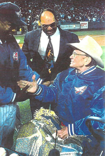 Former Angels players Rod Carew (‘79-‘85) and Reggie Jackson (‘82-‘86) offer congratulations to Angels owner Gene Autry on opening day April 8, 1998. (Photo courtesy Billy Holcomb.) 