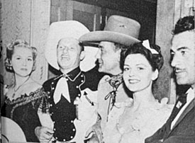 Virgina Mayo (left), unknown, Buck Jones, unknown, Errol Flynn at the “Virginia City” premiere.. 
