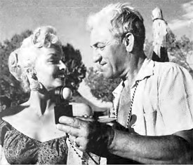 Director of Photography Walter Strenge checks lighting on Mari Blanchard for a 
scene in “Stagecoach to Fury” (‘56 Fox). 
