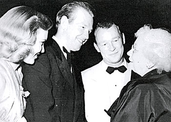 Rex Allen and his wife are introduced to Ida Koverma by Roy Rogers at a dinner to honor Adolph Zukor. Koverma came to give thanks to the Western stars for appearing at many of her benefits. 
