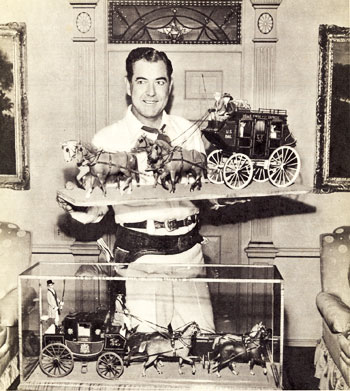 Johnny Mack Brown, an enthusiastic collector of old west model coaches, shows off a couple of recent additions to his collection. 