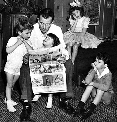 John Wayne reads the December 20, 1942 Sunday comics to his children...Michael, Mary Antonia (Toni), Patrick and Melinda. 