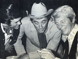 At a 1971 Hollywood party, perhaps a bit tipsy, Christopher George, Robert Mitchum and Peter Graves swap a few lies.