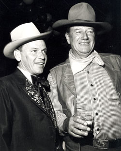 Frank Sinatra and John Wayne attend a SHARE party fundraiser in Beverly Hills.