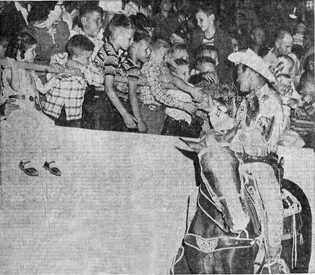 Above three photos taken during Roy Rogers’ appearance in early October 1957 for the New Mexico State Fair in Albuquerque. Top photo, Roy signs an autograph for 14 year old Janet Latsha. In the second photo Roy displays one of his guns for two members of a family of ten orphaned earlier in the year, Eddie and Gregory Chavez. In the third photo Roy shakes hands with children at the State Fair Coliseum.