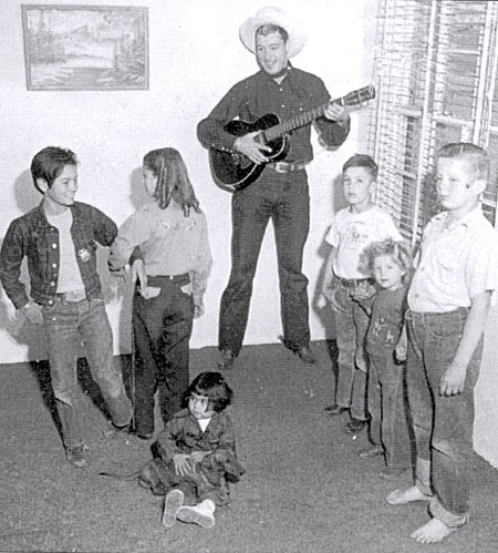 Delores Randall and Don “cut a rug” as Jim (Red Ryder) Bannon provides the music while neighborhood kids look on circa 1949.
