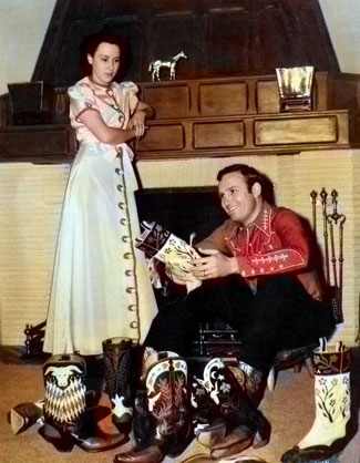 Gene Autry and wife Ina ponder over which pair of boots Gene should wear 
to dinner tonight. Photo taken in 1939. 