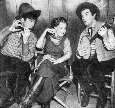 While filming “Girl of the Golden West” in 1938 star Jeanette MacDonald is serenaded by flutist Buddy Ebsen and banjoist Cliff Edwards. Jeanette doesn't seem particularly impressed with the music.