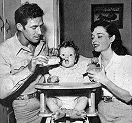 “Range Rider”, “Yancy Derringer”—Jock Mahoney and wife/actress Margaret Field feed daughter Princess.