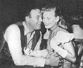 “Shotgun Slade”—Scott Brady at Guy Madison’s birthday party in 1954 snuggles up to beer heiress Beverly Pabst. 