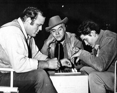 Lorne Greene carefully observes the mental struggle between Dan Blocker and
Michael Landon. 