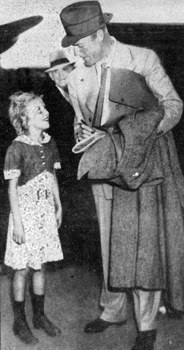 Eleven year old Jean McKelvy of Bowling Green, OH gets an autograph from Randolph Scott at the Washington D.C. airport on October 1, 1937. 