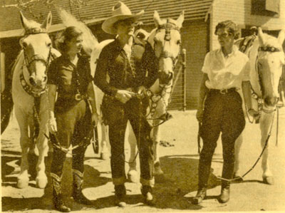 Outside the Buck Jones stable (L-R) daughter Maxine, Buck and Silver and wife Dell. 