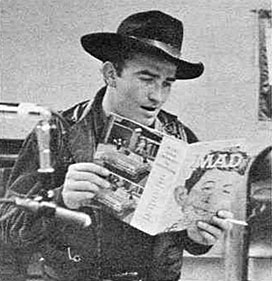 At a horse show in Jackson, MS, the Virginian, James Drury, takes time out to look at MAD Magazine’s spoof on his series calling him James Droopy and the Virginiaham. 