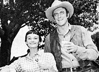 Guest star Gloria Talbott and James Arness take a break from filming the fourth episode of “Gunsmoke”, “Home Surgery” (‘55). 