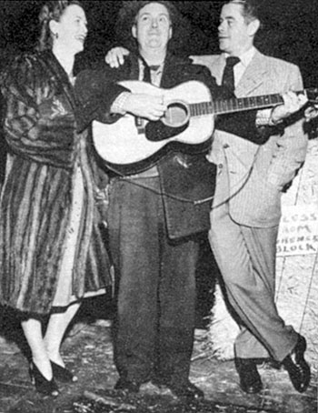 Smiley Burnette seranades Glenn Ford and ?? at the Hitching Post Theater 
in the late ‘40s. 