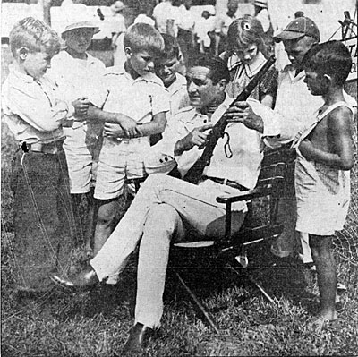 Tom Mix points out a little gun safety to some young fans while his Tom Mix Circus played in Toledo, OH on August 5, 1935. 