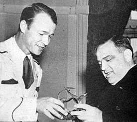Roy presents a pair of silver spurs to Mayor Fiorello LaGuardia during a New York visit. 