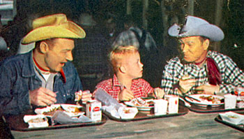 Young Deever Jenkins gets a treat lunching with Pat Brady and Roy during the making of a June 1955 “Roy Rogers Show” TV episode. 