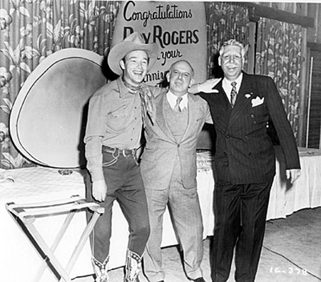 Roy, Republic President Herbert J. Yates and Roy’s business manager Art Rush celebrate Roy’s ninth year at Republic in 1947. 