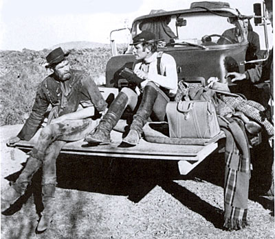 James Coburn chats with Charlton Heston while taking a break from filming 
“Major Dundee”.