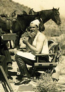 Ken Maynard applies his own make-up on location for another of his great Westerns.
(We are currently the proud owners of that exact make-up kit.)