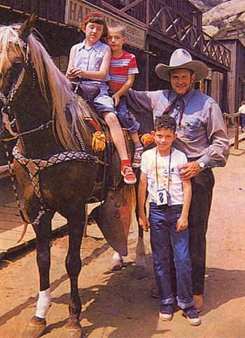 Ray “Crash” Corrigan poses at Corriganville with members of the Dohren family of Aurora, Illinois, in 1956.
