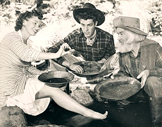 Karin Booth, Dale Robertson and Gabby Hayes have a little fun panning for gold during the making of “Cariboo Trail” (‘50).