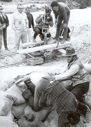 Director Sergio Leone (white shirt) films a scene with Clint Eastwood and Eli Wallach just after the bridge explosion in “The Good, The Bad and The Ugly”. 