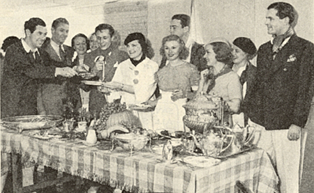 Johnny Mack Brown (far left) with friends at a dinner feast in 1934. 
