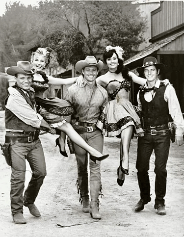 Neville Brand, William Smith and Peter Brown escort a couple of dancehall cuties during the making of a “Laredo” TV episode.
