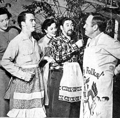Betty and Dick Jones, Sheila Ryan and husband Pat Buttram make ready for a cookout at the home of Gene Autry. 