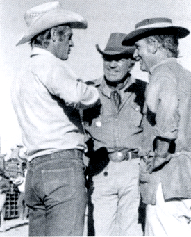 Steve McQueen, Robert Preston and director Sam Peckinpah discuss a scene on location in Prescott, AZ, for “Junior Bonner” (1972). 