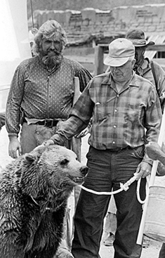 Bozo, the grizzly bear, is petted by owner/trainer Lloyd Beebe as actor Gene Edwards watches on the set of “The Legend of Grizzly Adams” at Old Tucson in 1989. Edwards doubled and did stunts for Dan Haggerty in the original “Grizzly Adams” TV series for 24 episodes from ‘77-‘78 before taking on the role for this one-shot movie. 