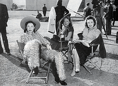 Judy Canova relaxes on the set of “Chatterbox” in March 1943 
along with Anne Jeffreys and Rosemary Lane. 