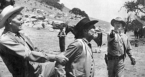 “Wagon Train”’s Ward Bond whips a cigarette from friend Frank McGrath’s mouth while Terry Wilson holds McGrath steady. Circa 1959. 