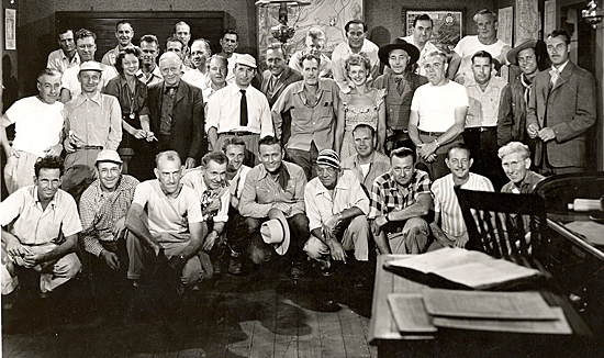 Cast and crew of “Lawless Code” (‘49 Monogram) starring Jimmy Wakely (kneeling in center). (Center Row L-R) Unknown, unknown, unknown, Steve Clark, screenwriter Basil Dickey, assistant director Eddie Davis, producer Louis Grey, director Oliver Drake, Ellen Hall, Kenne Duncan, unknown, unknown, Terry Frost, Tris Coffin plus a host of other crew members. 