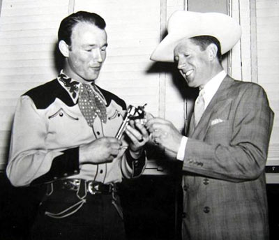 A young Roy Rogers and crooner Rudy Vallee do a little “gun-work”.