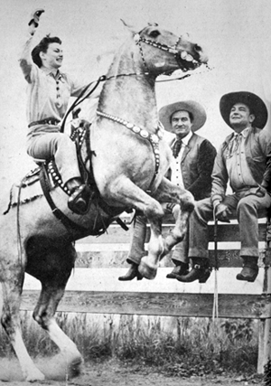 Buck Jones’ daughter Maxine rears a Palomino as Tom Mix and Buck Jones
approvingly watch at a ranch north of Hollywood in the mid-‘30s. 