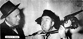 Smiley Burnette looks like he's jury-rigged a six gun to radio station WMFC's microphone in Monroeville, AL. 