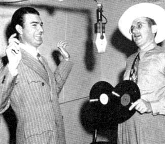 RCA Victor gag photo as band leader Tommy Dorsey holds up Tex Williams with two records instead of two guns (11/48).